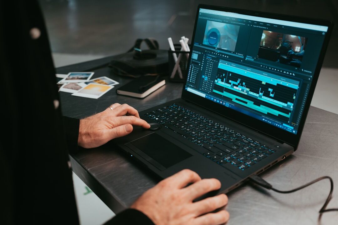 woman editing video on laptop